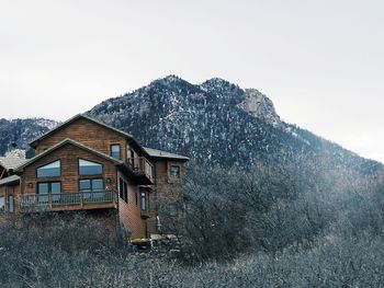 House on mountain against clear sky