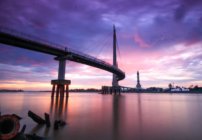 Bridge over river against sky during sunset