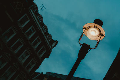 Low angle view of illuminated street light against sky at night