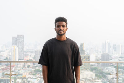 Portrait of handsome young african man wearing oversized black t-shirt