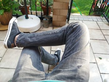 Low section of man sitting on seat