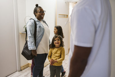 Smiling woman with daughter visiting medical clinic