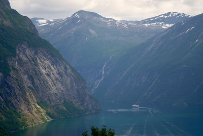 Scenic view of mountains against sky at entry of geirangerfjord