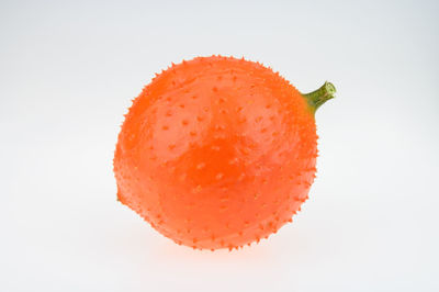 Close-up of orange slice against white background