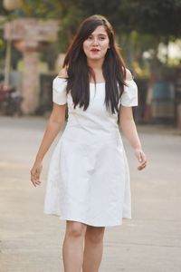 Beautiful young woman walking on road