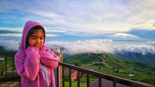 Girl standing outdoors against mountain