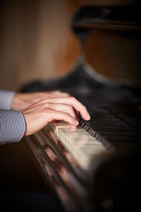 Midsection of man playing piano