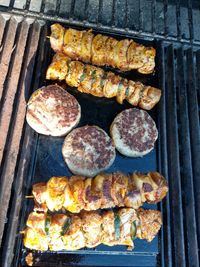 High angle view of meat on barbecue grill