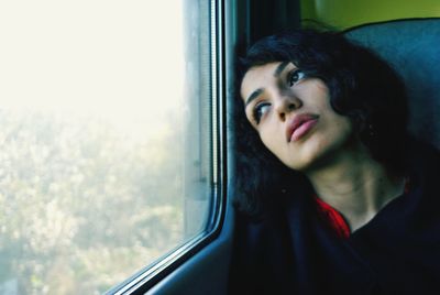 Portrait of man looking through train window