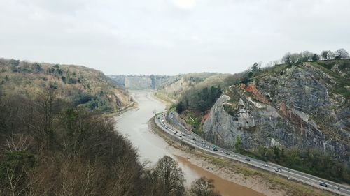 Scenic view of river amidst mountains against sky