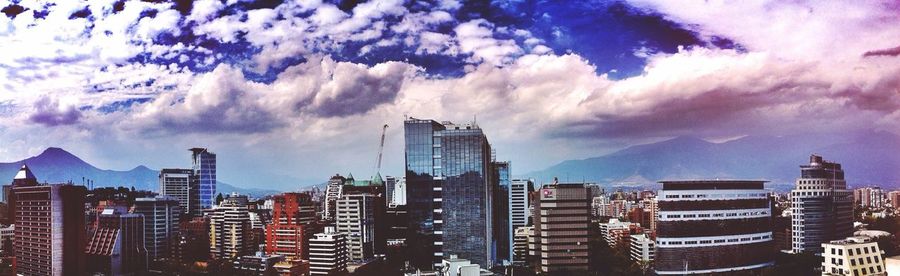 Buildings against cloudy sky