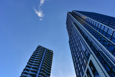 Low angle view of modern building against blue sky