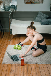 Young woman lying on table at home