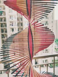 Close-up of multi colored umbrellas hanging on window