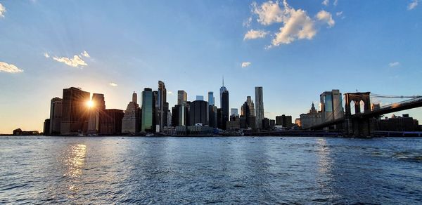 Sunset over lower manhattan - panoramic view of buildings against sky during sunset