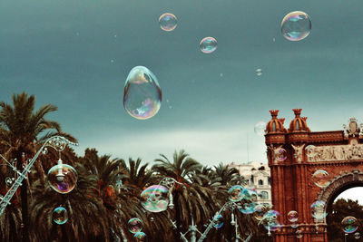 Low angle view of bubbles against sky