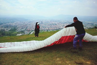 Full length of woman standing on mountain against sky