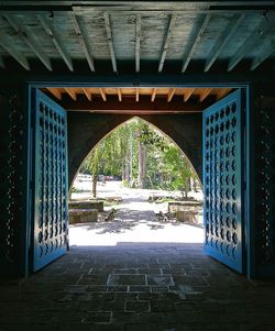 Bridge over footpath amidst buildings in city