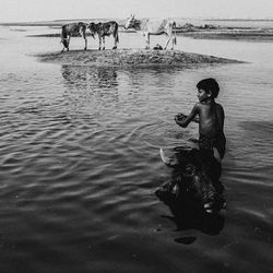 Full length of shirtless man in water