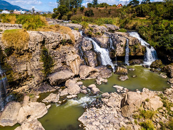 Scenic view of river flowing through rocks