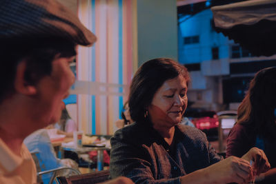 Mature woman sitting at restaurant