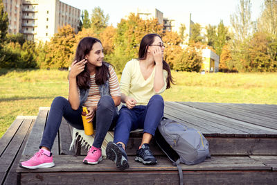 Side view of young woman using mobile phone