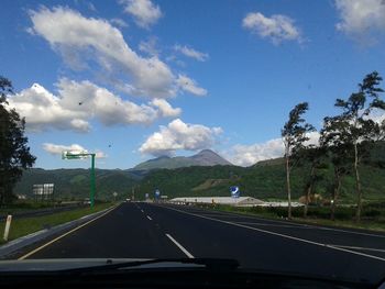 Cars on road against sky