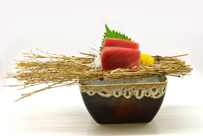 Close-up of cake on table against white background