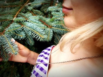 Close-up of woman with christmas tree