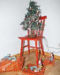 Christmas tree on table against wall at home