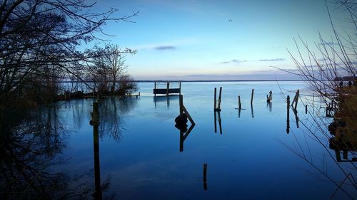 Scenic view of lake against sky at sunset