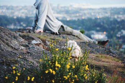 Low section of person on rock in sunlight