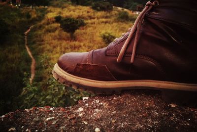 Close-up of shoes on field