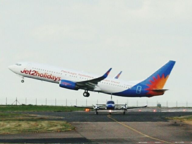 LOW ANGLE VIEW OF AIRPLANE IN SKY