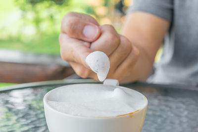 Close-up of hand holding cup