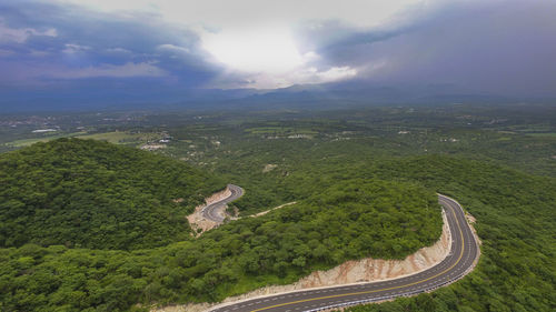 High angle view of green landscape against sky