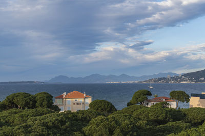 Scenic view of sea and buildings against sky