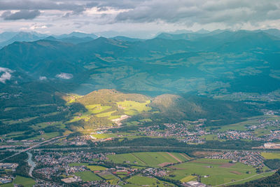 Aerial view of green landscape against sky