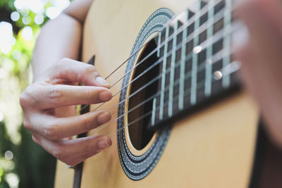 Cropped image of man playing guitar