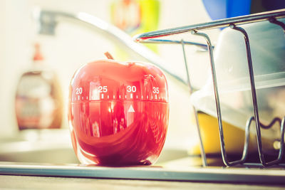 Close-up of red container with numbers on table