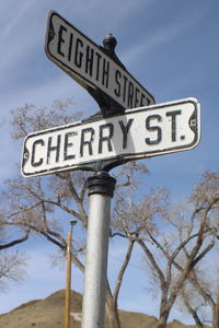 Low angle view of road sign against sky