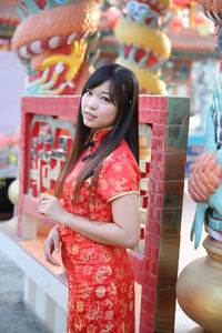 Young woman in traditional clothing standing outdoors