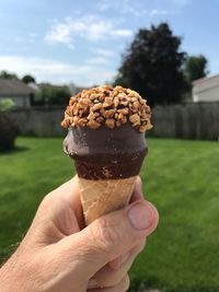 Close-up of hand holding ice cream cone