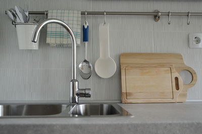 Close-up of faucet over sink on counter at kitchen