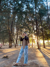 Full length of man standing by tree