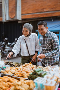 Portrait of smiling man holding food at farm