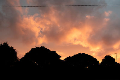 Low angle view of silhouette trees against sky during sunset