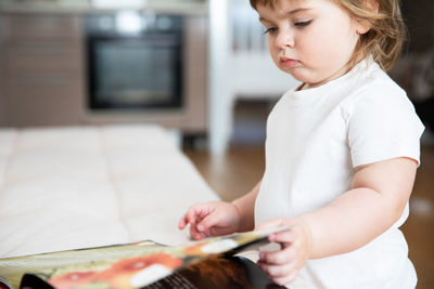 Side view of young woman using mobile phone at home