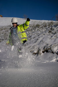 Photography of young woman having fun with snow