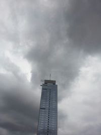 Low angle view of building against cloudy sky